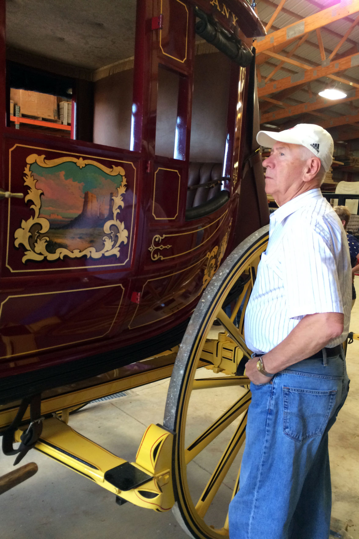 106 Franklin Hronik examines the wagons at Hansen Wheel and Wagon Shop.JPG